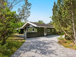A single-story building with a gravel driveway leading to a wooden deck. - 6 Person Holiday Home in Glesborg (Glesborg)