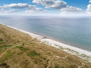 An aerial view of a beach with a clear sky and a calm sea. - 5 Star Holiday Home in Albaek (Aalbaek)