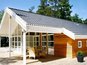 A modern house with a covered porch, large windows, and a wooden exterior. - 5 Star Holiday Home in Aakirkeby (Akirkeby)