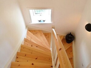 A wooden staircase with a white handrail and a small skylight at the top. - Delicate Holiday Home in Harboøre near Sea (Harboore)