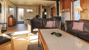 A cozy living room with a sofa, a coffee table, and a fireplace. - Spacious Holiday Home in KarrebÃ¦ksminde near Fishing (Karrebæksminde)