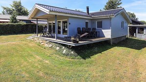 A single-story house with a covered patio area, a chimney, and a small deck. - Spacious Holiday Home in KarrebÃ¦ksminde near Fishing (Karrebæksminde)