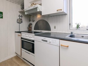 A kitchen with white cabinetry, a stove, an oven, a dishwasher, and a sink.