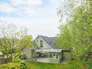A house with a covered patio, a garage, and a fenced yard. - Spacious Holiday Home in Hemmet near Sea (Hemmet)