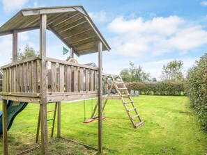 A wooden play structure with a slide and a ladder. - 5 Star Holiday Home in Juelsminde (Horsens)