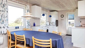 A modern kitchen with white cabinets, a built-in oven, and a sink. - 6 Person Holiday Home in Ringkobing (Ringkobing)