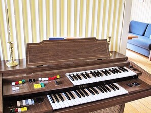 A Yamaha piano with a wooden finish, multiple control knobs, and a keyboard. - 6 Person Holiday Home in Vaeggerlose (Vaeggerlose)