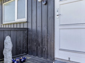 A wooden exterior with a white door and a window with a screen. - 5 Star Holiday Home in Hjorring (Hjørring)