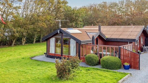 A modern house with a sloped roof, large windows, and a well-maintained lawn. - 6 Person Holiday Home in Vestervig (Vestervig)