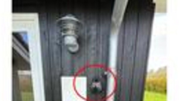 A door with a metal handle, a vent, and a yellow sign. - Quaint Holiday Home in Hemmet near Fjord (Hemmet)