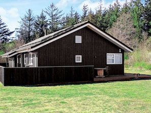A rustic wooden cabin with a sloped roof, a small porch, and a number '1' sign. - 8 Person Holiday Home in Brovst (Brovst)