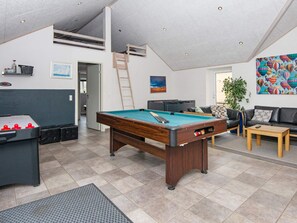 A spacious living area with a pool table, a foosball table, a sofa, and a coffee table. - 5 Star Holiday Home in Romo (Rømø)