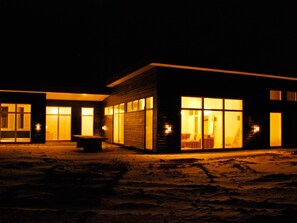 A modern building with large windows and a well-lit entrance.