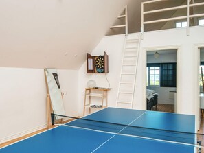 A room with a ping pong table, a dartboard, and a ladder. - Luxurious Holiday Home in Jutland with Hot Tub (Aabenraa)