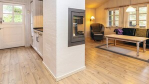 A modern interior with a kitchen, dining area, and seating space. - 6 Person Holiday Home in Albaek (Aalbaek)