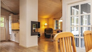 A wooden interior with a kitchen, dining area, and a large window. - 6 Person Holiday Home in Albaek (Aalbaek)