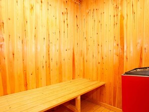 A sauna room with wooden walls and a bench. - 6 Person Holiday Home in Albaek (Aalbaek)