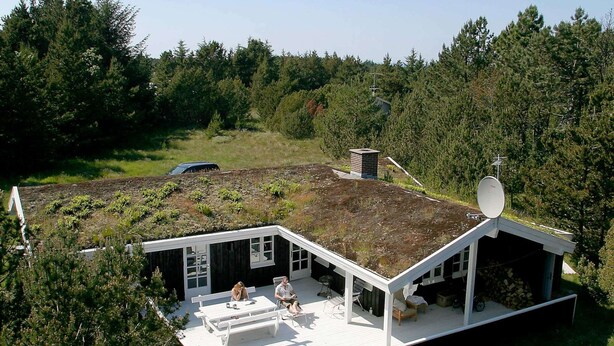 A modern house with a sloped roof, a deck, and a satellite dish. - 6 Person Holiday Home in Albaek (Aalbaek)
