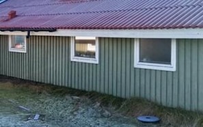 A single-story building with a corrugated metal roof and a small window. - 4 Star Holiday Home in Fano (Fano)