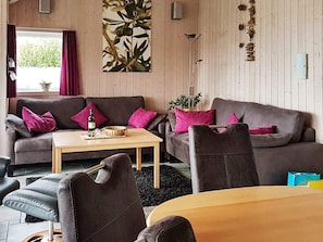 A cozy living room with a sofa, armchair, and coffee table.