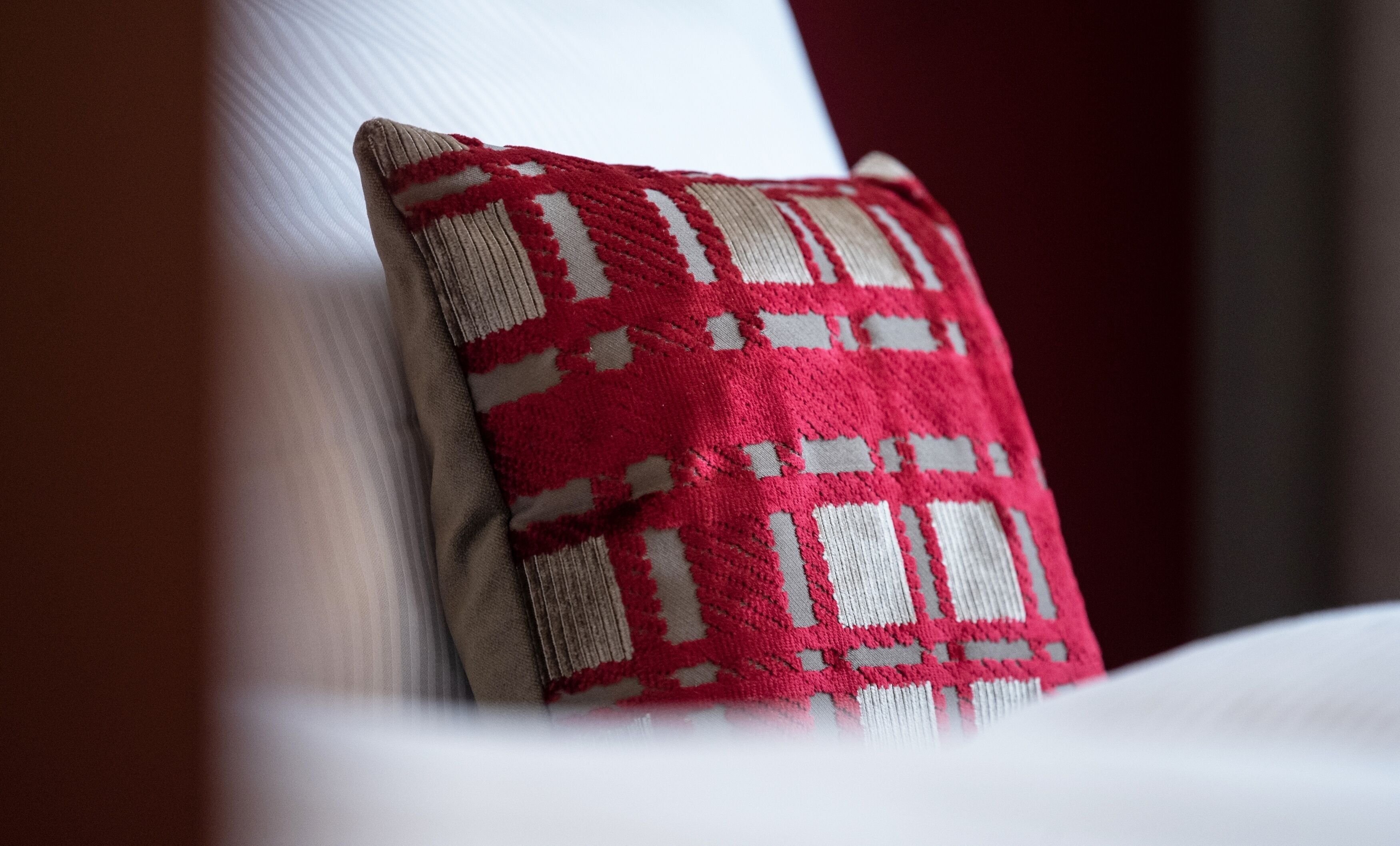 A close-up of a pillow with a geometric pattern.