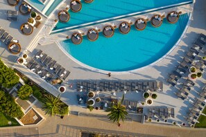 An aerial view of a resort with a large pool, sun loungers, and palm trees. - King Jason Protaras - Designed for Adults By Louis Hotels (Paralimni)