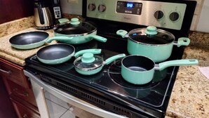A kitchen with a stove, pots, pans, and a coffee maker. - Spacious 3/2/ condo located minutes from downtown area of Beautiful Tamarindo  (Tamarindo)