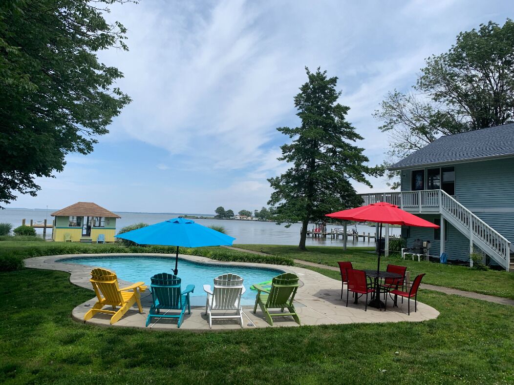 Waterfront property on 3/4 acres with private beach, pool, hot tub, and pier.