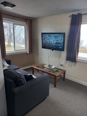 Front room with wall mounted TV with swivel

