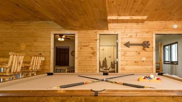 Enjoy a game of pool in this inviting room with a pool table and warm atmosphere.