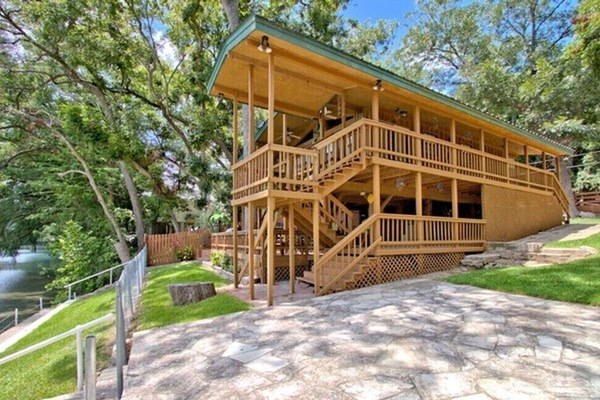 Our Beautiful River Front Treehouse Cabin! The outdoor deck offers comfy outdoor furnishings make it easy to relax and waste the day away with the amazing views. Even Fido can enjoy the comforts of this river house getaway.