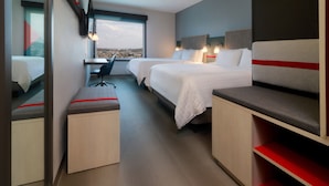A modern hotel room with two beds, a desk, and a chair. - avid hotel Fresnillo by IHG (Fresnillo)