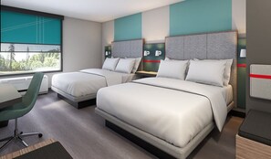A hotel room with two beds, a desk, and a chair.