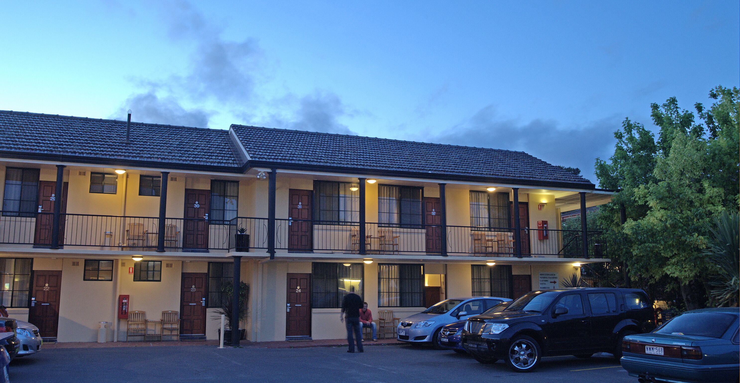 A two-story motel with a parking lot.