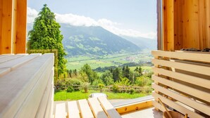 A wooden cabin with a large window overlooking a valley and mountains. - Nice apartment for 20 people with WIFI, TV and balcony (Schlitters)