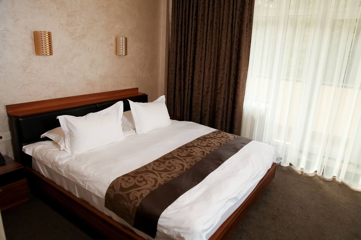 Premium bedding, desk, laptop workspace, blackout curtains
