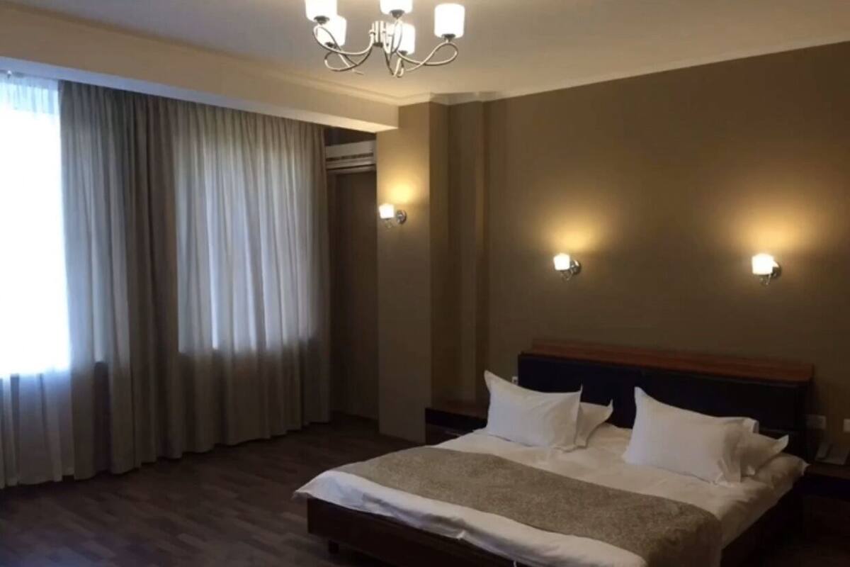Premium bedding, desk, laptop workspace, blackout curtains