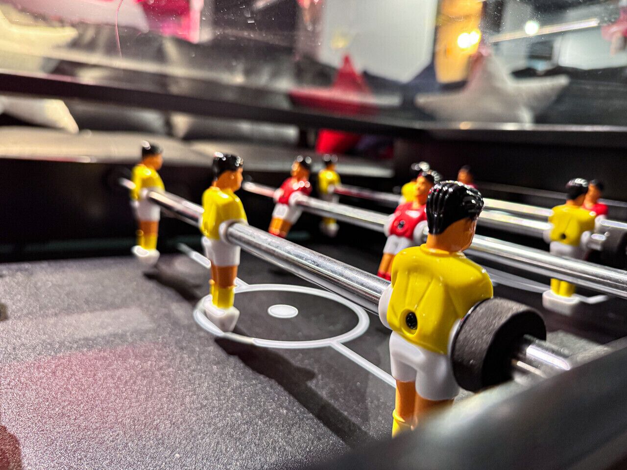 A close-up of a table with miniature figures in yellow and red uniforms, suggesting a themed event or display.