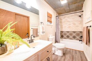 Bathtub, hair dryer, towels, soap