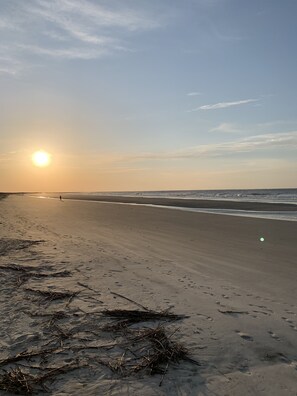 Enjoy a serene beach experience with gentle waves lapping at the shore.