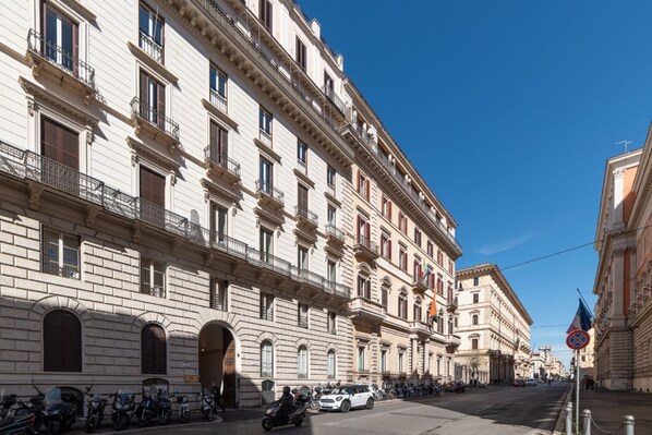 A multi-story building with a classical architectural style, featuring arched windows and balconies.