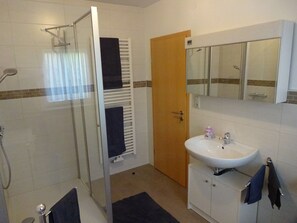 Shower, hair dryer, towels, toilet paper
