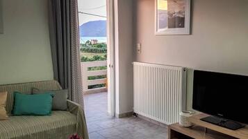 Comfort Apartment, 1 Bedroom, Sea View, Garden Area | Living area | 44-inch LCD TV with cable channels, TV