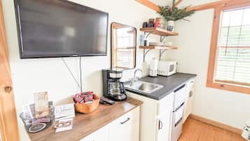 Fridge, microwave, coffee/tea maker, cookware/dishes/utensils