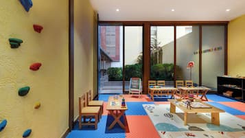 Kids can play and learn in this play area with a climbing wall, play table, and educational materials.