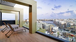 A balcony with a view of a cityscape and water. - Mercure St. Julian's Malta (St. Julian's)