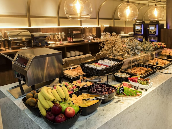 A buffet with various fruits, vegetables, and prepared foods. - Mercure St. Julian's Malta (St. Julian's)