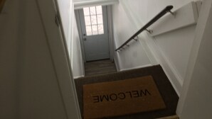 A staircase with a "WELCOME" mat at the bottom. - Lilly’s Place is cozy and relaxing every room has it’s own unique style. (Glasco)