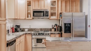 A kitchen with wooden cabinets, a stainless steel refrigerator, a microwave, a stove, and a dishwasher. - Mt Baker Lodging's Cabin #1 - With Wifi, Hot Tub, Pet Friendly (Deming)