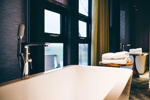 Designer toiletries, hair dryer, slippers, towels